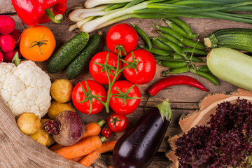 Pile of various vegetables on wood. Raw healthy vegeterian food.