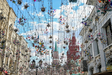 Festival lights hanging over a street by Red Square