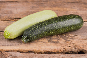 Fresh marrows with different color, close up. Squash vegetable marrow zucchini on wooden desk table.
