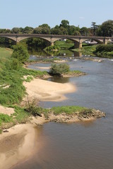 Pont au dessus de l'Adour et rivage avec sable et végétation ville thermale de Dax Landes  temps ensoleillé