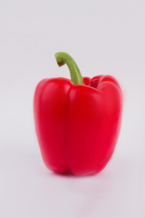 Red bell pepper isolated on white. One single paprika pepper, close up.