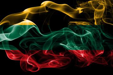 Fototapeta premium National flag of Lithuania made from colored smoke isolated on black background. Abstract silky wave background.