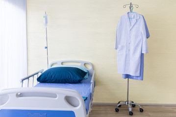 Hospital room with empty bed,infusion set , intravenous fluid and doctor suite to creative for design and decoration on background.Copy space.