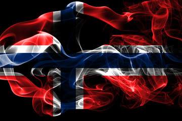 National flag of Norway made from colored smoke isolated on black background. Abstract silky wave background.