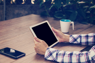 Asian businesswoman in the cafe and using tablet on table.