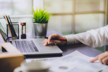 The accountant checking documents about graph and chart relating to financial reporting and tax accounting of the company