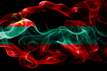 National flag of Transnistria made from colored smoke isolated on black background. Abstract silky wave background.