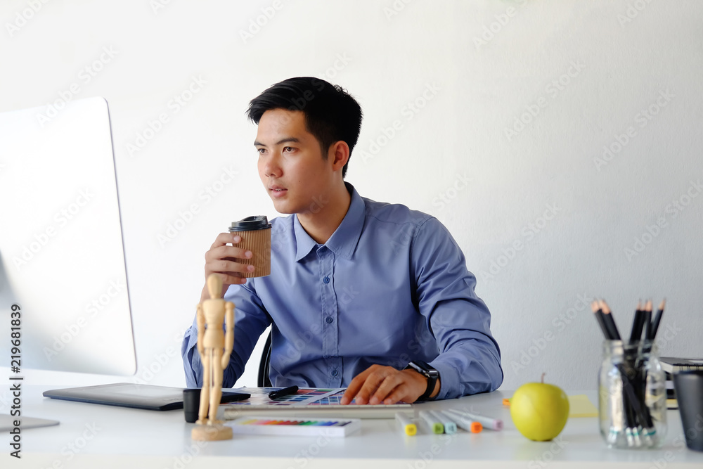 Poster graphic designer working with computer on table.