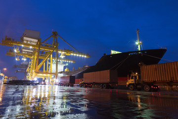 Fototapeta na wymiar Shipping & Logistics background with Cargo operation at Port at night.