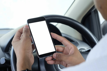 Close up man hands using smartphone in automobile.
