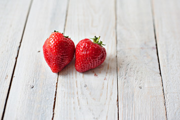 Beautiful juicy berries of strawberry on a wooden background