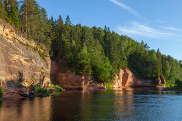 Peaceful landscape with Gauja river and red sandstone (Erglu klint) steep rocks in Gauja National...
