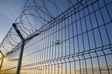 Fence with barbed wire.