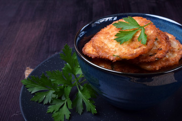 Vegetable pancakes topped with parsley leaves