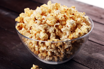 Cinema concept with popcorn on rustic table