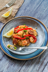 Spanish paella with prawns, chicken, chorizo and red pepper - high angle view