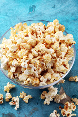 Cinema concept with popcorn on rustic table