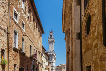 Fototapeta na wymiar Street of Montepulciano, Italy and the Tower of Palazzo Comunale
