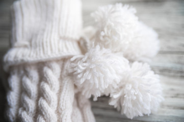 White knitted socks, handmade socks on white background. Texture of knitted things