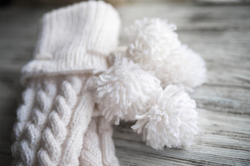 White knitted socks, handmade socks on white background. Texture of knitted things