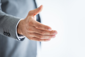 businessman extending hand to shake