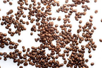Scattered Brown Coffee Beans on White Background