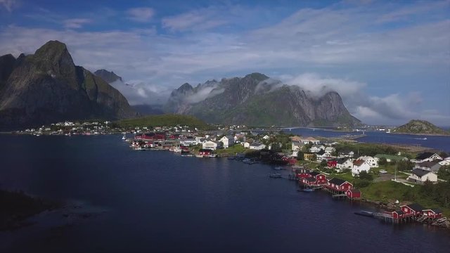 Aerial view of small village in Norway, Hamnoy. This is a small fishing village on the lofoten islands, and popular tourist destination with its typical red houses and natural beauty. 4k