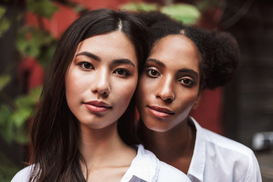 Portrait of beautiful girls in white shirts dreamily looking in camera