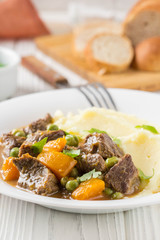 Beef stew, pumpkin and green peas with mashed potatoes.  Delicious homemade dinner. Autumn food