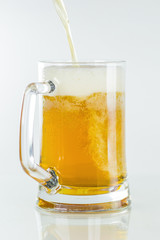 Beer to pour into glass on an isolated background a foam rises on a white background.