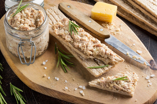 Tuna pate with egg, cheese in jar and crispy bread. Fish rillette, healthy snack, diet food