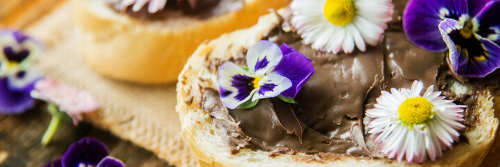 Sweet berry bruschetta with chocolate nut butter,mint and sliced almonds on the white vintage dish
