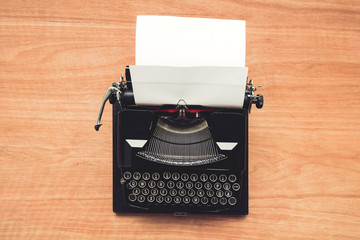 Vintage typewriter machine on writers desk