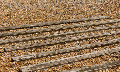 wooden slats on a pebble beach for boat beaching