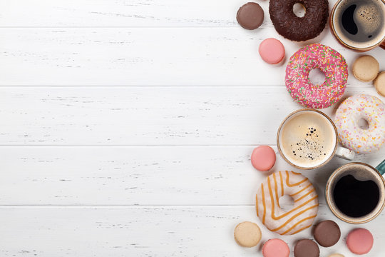 Coffee cups, donuts and macaroons