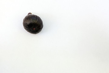 Fresh ripe sweet figs on white paper with copy space.