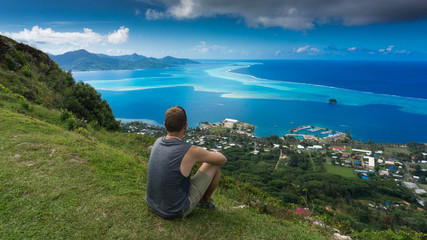 Naklejka na ściany i meble Relaxing On Top of Raiatea's Mt Topioi And Enjoying The Blue Lagoon - French Polynesia
