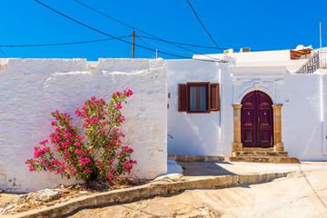 Traditional greek houses with spring flowers on Rhodes island. Lindos village, Dodecanese, Greece.