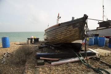 Scenic lanscape of lovingly oiled fishing wooden fishing boat on a shingled beach