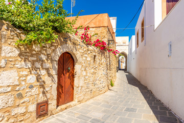 Beautiful Greek street with summer flowers in Lindos village. Rhodes island. Greece. © vivoo