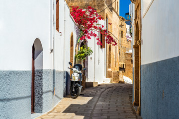  Beautiful narrow street of historic Lindos. Rhodes island, Greece © vivoo
