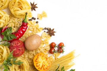 Different types of italian pasta, nests, spaghetti, spices, Red hot chilli pepper, chicken eggs, tomatoes, cherry, light white stone background. Flat lay, top view