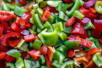 Food background, texture. Vegetarian useful mixture. Chopped bell peppers of different colors: red, green, yellow, black. Fresh vitamins and antioxidants, sweet peppers, vegetables 