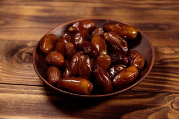 Dried dates fruit on wooden table