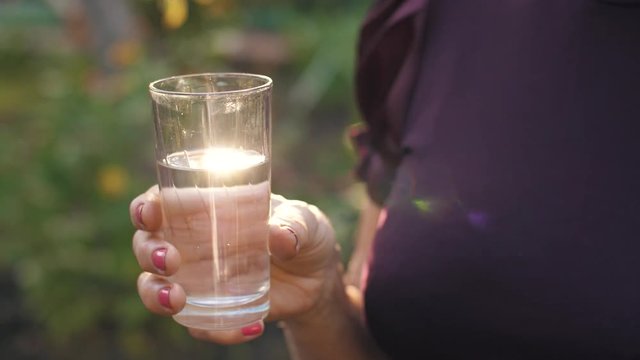 Glass of water in woman's hand