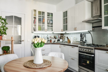 Bouquet of tulips in interior of the kitchen - obrazy, fototapety, plakaty