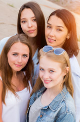 Fototapeta premium four femle friends looking friendly at camera, smile, happy. people, lifestyle, friendship concept
