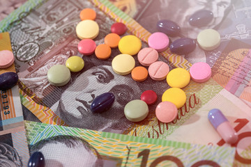 Different dispersed pills on australian dollar banknotes