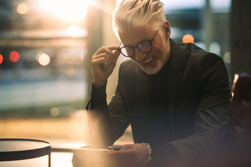 Businessman enjoying watching online video on his mobile