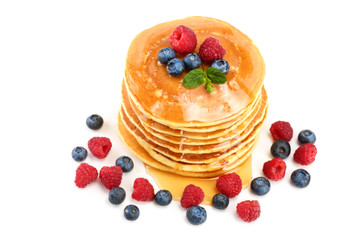 Pancakes stack with different berries and honey isolated on white background